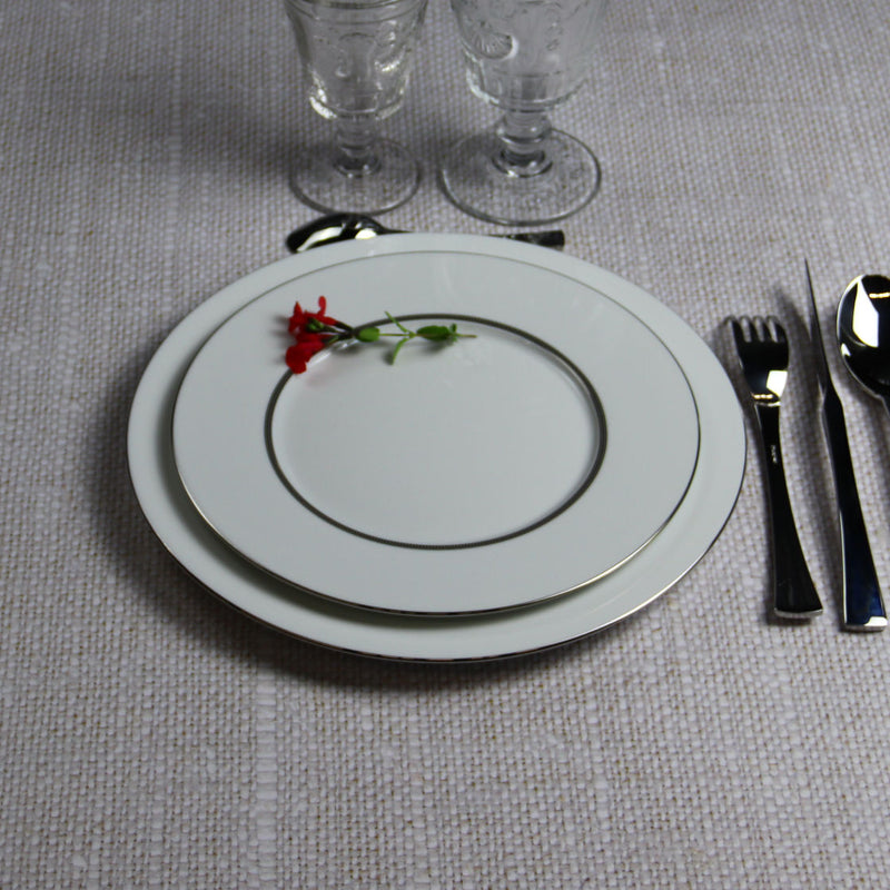 Degrenne plates set on linen with red salvia