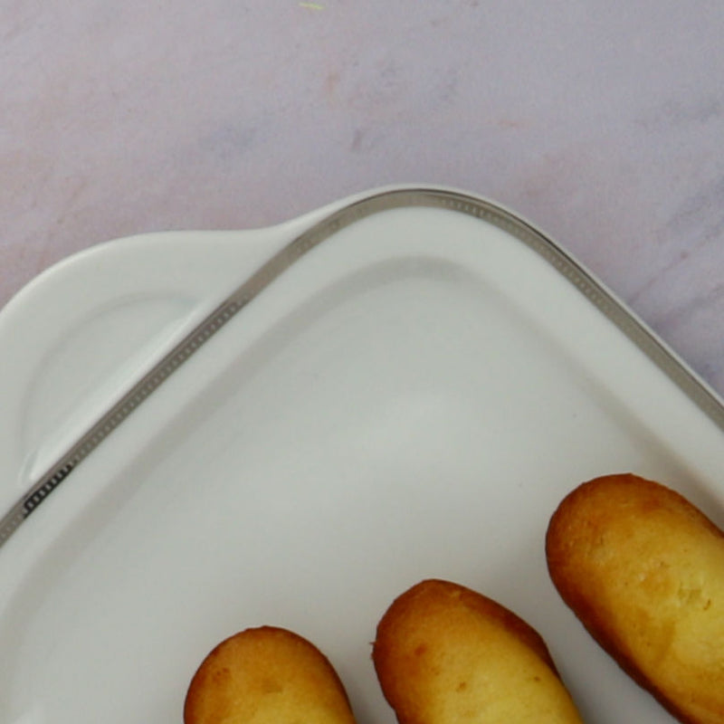 Cake dish with three madeleines zoomed